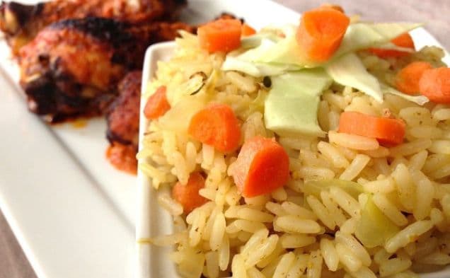 Peri peri chicken drumsticks beside savoury rice with carrots